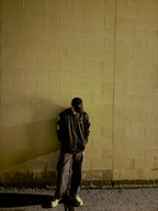 Person wearing black tokko fuku jacket standing against a wall