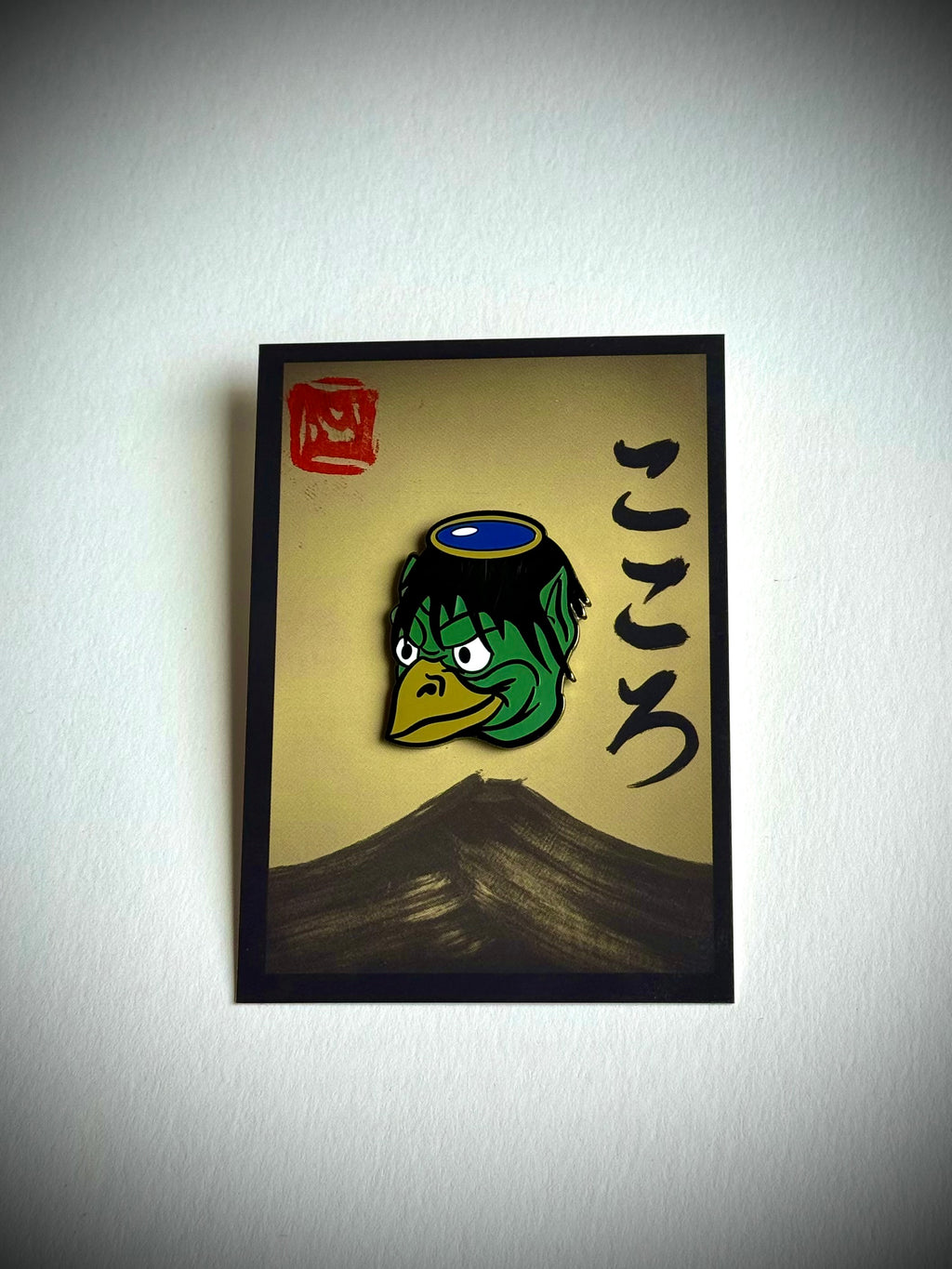 Kappa enamel pin on a cream Kokoro backing card with a hanko stamp