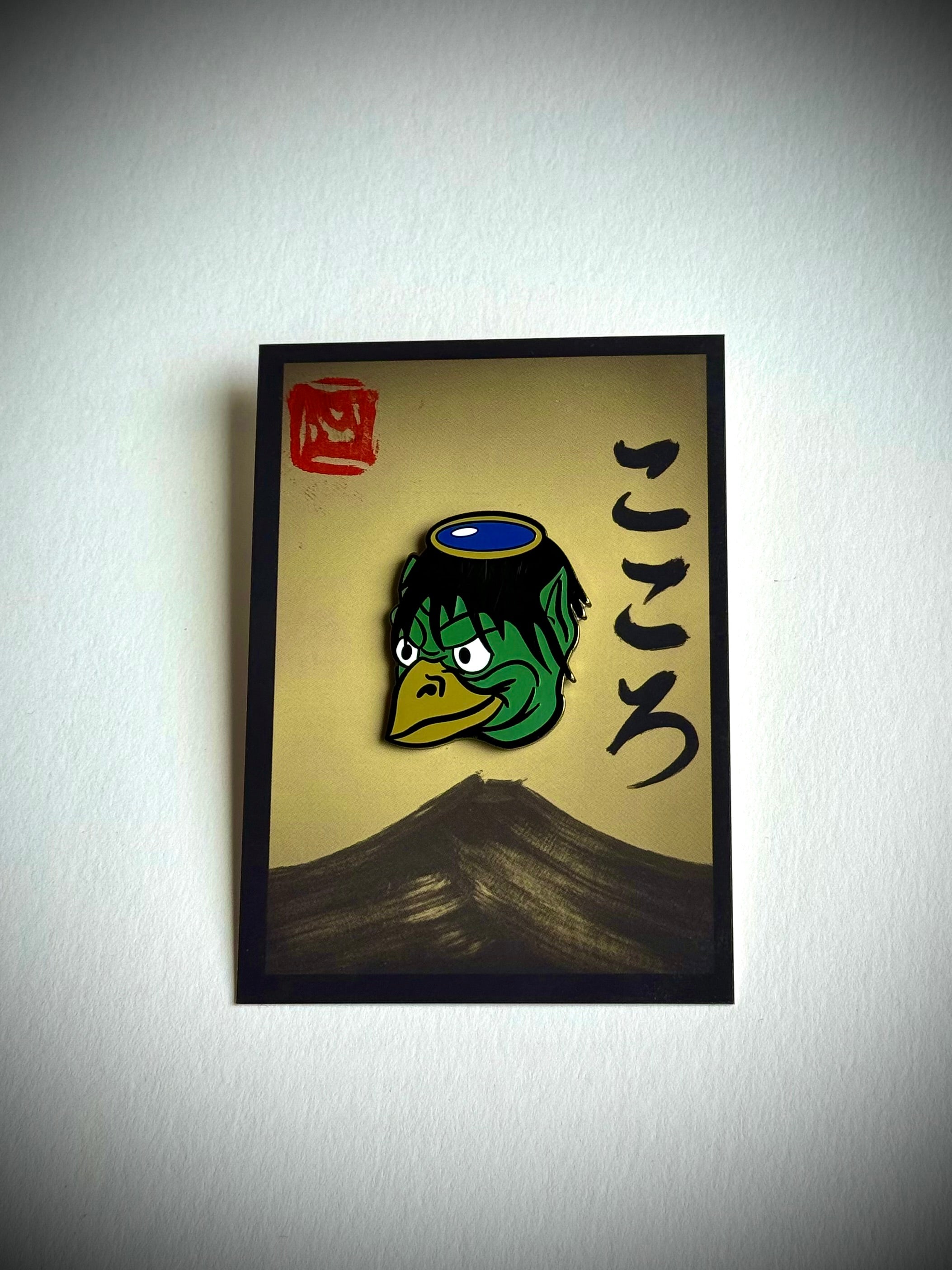 Kappa enamel pin on a cream Kokoro backing card with a hanko stamp
