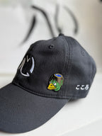 Kappa enamel pin on an embroidered, black Kokoro hat with Kokoro calligraphy in the background
