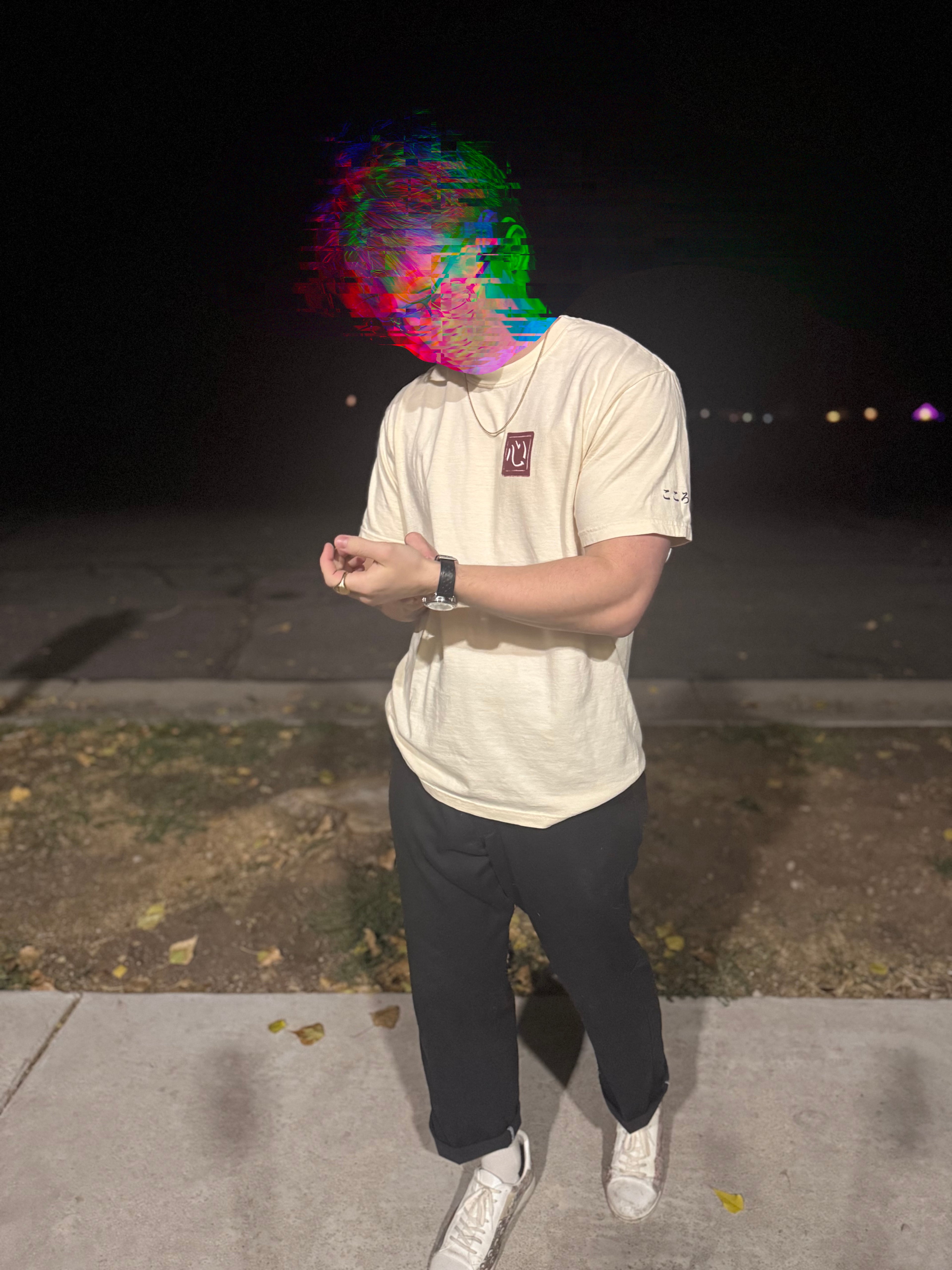 Front view of person wearing cream tee with red Kokoro hanko stamp graphic on the left chest