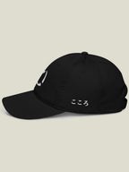 Black dad hat with white embroidery of Kokoro hiragana on the left side