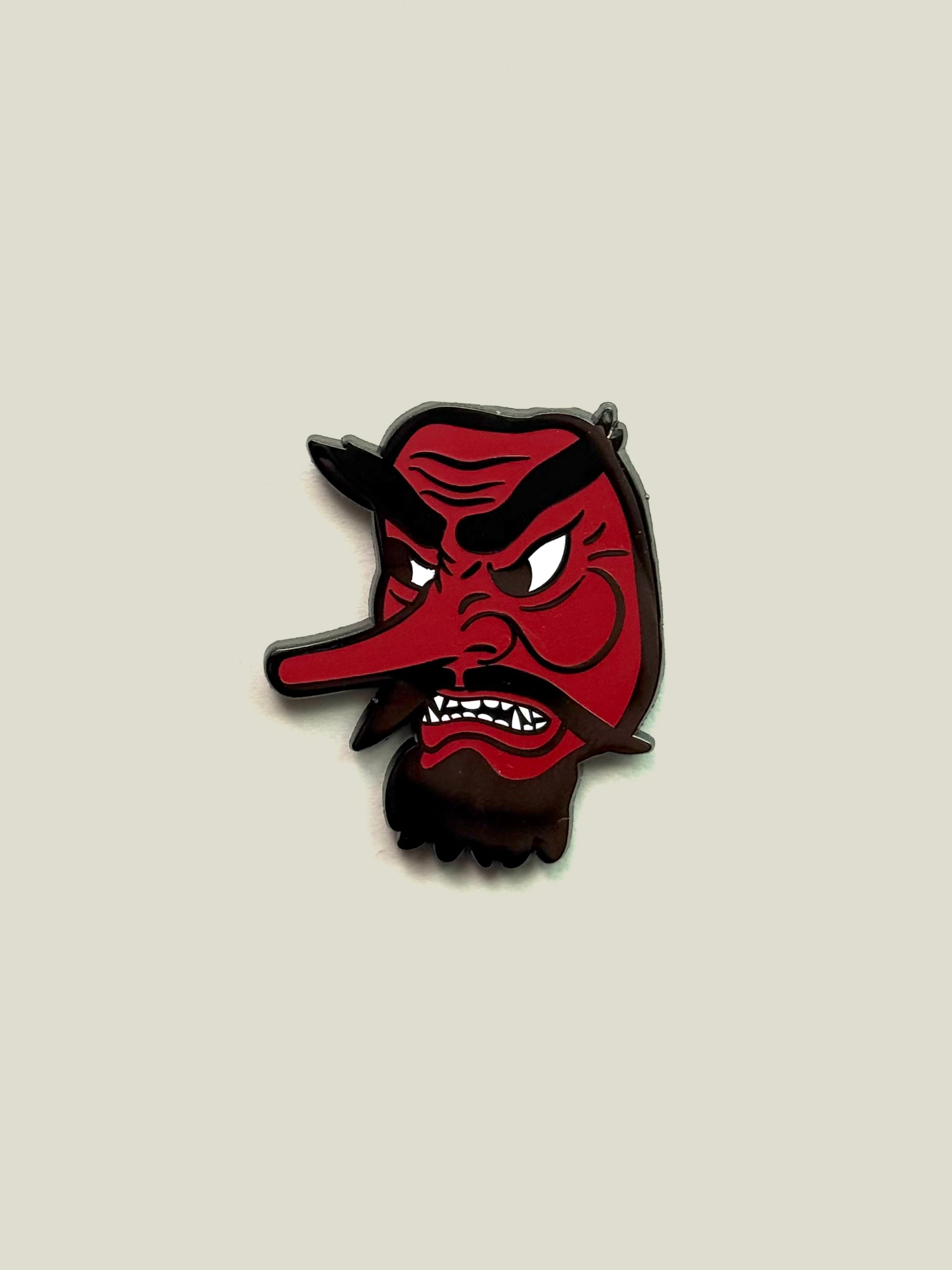 Red Tengu enamel pin with black nickel finish